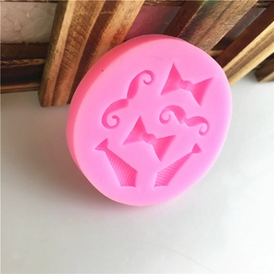 Pink silicone mold for fondant featuring mustache, bowtie, and necktie shapes