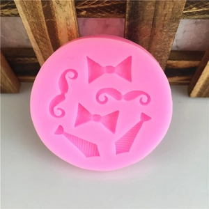Pink silicone mold with mustache, bowtie, and necktie shapes for DIY fondant cake baking