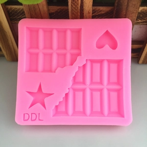 Pink silicone mold for DIY waffles, chocolates, stars and hearts on a wooden background