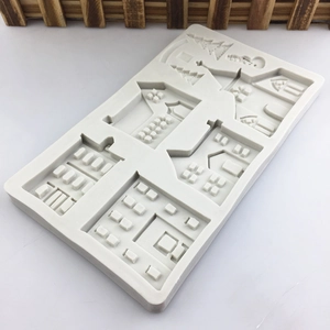 Christmas gingerbread house silicone baking mold featuring snowy pine trees and cabins