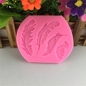 Pink silicone mold featuring four detailed feather patterns for cake decoration and DIY crafts