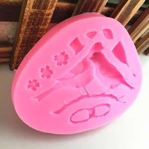 Pink silicone mold featuring bird, cherry blossoms, and leaves for DIY cake decorating