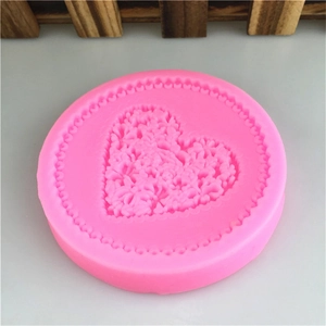 Pink circular silicone mold with embossed heart flower pattern for DIY baking crafts
