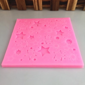 Pink square silicone mold featuring multiple hollow star and sparkle shapes for DIY baking