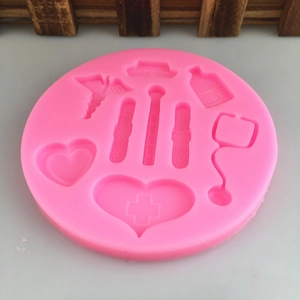 Pink silicone mold with medical shapes like stethoscope and nurse hat for DIY baking