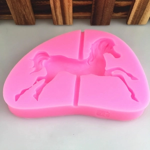 Pink carousel silicone mold for DIY baking and chocolate crafting on a white background