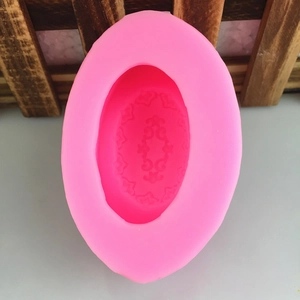 Pink oval silicone mold with intricate Baroque relief for DIY handmade soap and plaster