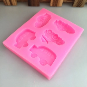 Pink silicone car mold with bus and plane shapes for DIY cake decorating and baking