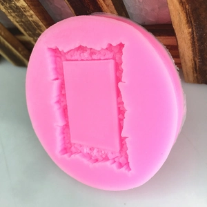 Pink silicone round mold featuring a rectangular frame with ornate European rock textures