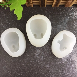 3D skull and bear silicone molds for DIY soap and chocolate making on a stone background