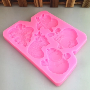Pink silicone mold featuring Christmas tree, snowman, and stocking shapes for DIY cake decor