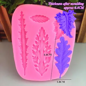 Pink silicone fern leaf fondant mold with detailed textures for chocolate cake decorating