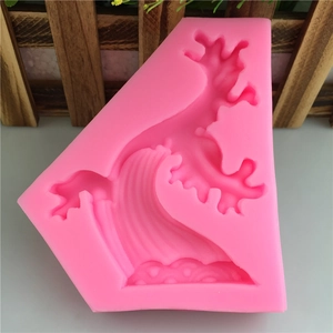 Pink silicone mold featuring wave and cloud patterns for DIY cake decorating and baking