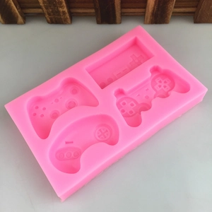 Pink silicone mold with four game controller shapes for chocolate and fondant cake decoration