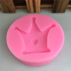 Pink round silicone mold featuring a crown design with heart detail for DIY fondant crafts