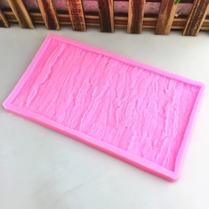 Pink silicone mold with realistic tree bark texture for DIY cake decorating and fondant