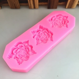 Pink silicone mold with three 3D rose flower shapes for cake decorating and DIY baking