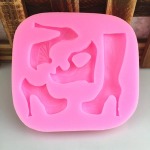 Pink silicone mold featuring four high heel and boot designs for cake decorating and DIY crafts