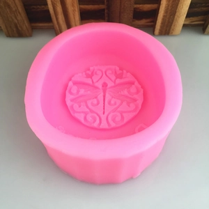 Pink silicone mold featuring dragonfly and floral patterns for DIY soap and candle making