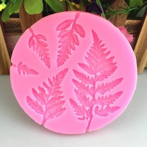 Pink silicone leaf mold for fondant and resin featuring various fern leaf textures