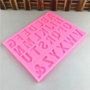 Pink silicone alphabet mold for chocolate and fondant with 26 uppercase letters and symbols
