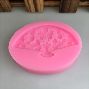 Pink silicone mold featuring detailed Chinese folding fan shape with floral textures