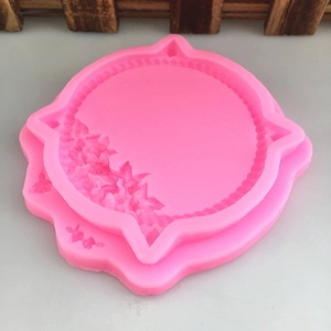 Detailed top view of a pink silicone mold with floral rose patterns for DIY crafts