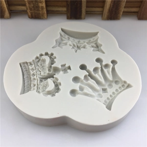 Detailed view of white silicone mold featuring three distinct vintage crown designs