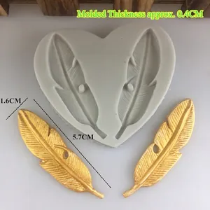 Silicone feather mold for cake decorating and plaster clay crafts with two gold feathers