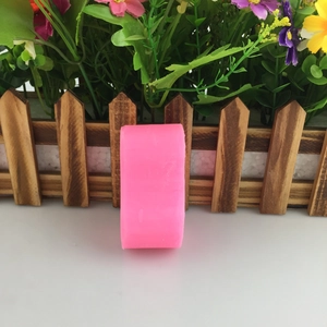 Pink silicone baby mold for candle making and baking with decorative flower background