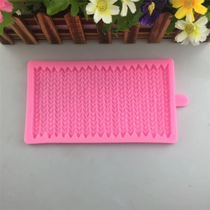 Pink silicone mold featuring intricate knitted textures for fondant and cake decoration