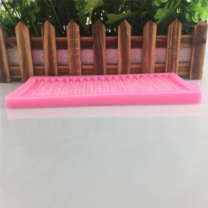 Pink silicone mold for cake decoration with textured knit and lace pattern design