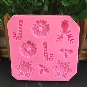 Octagonal pink silicone Christmas mold featuring snowflake, reindeer, and candy cane shapes