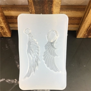 Translucent silicone mold featuring two detailed wing shapes for resin jewelry making