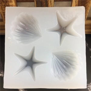 White silicone mold featuring seashell and starfish shapes for DIY candles and handmade soaps
