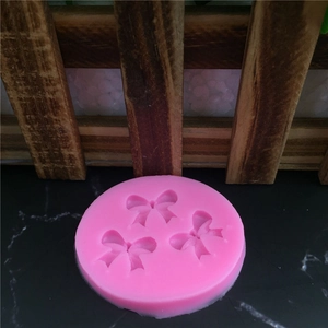 Pink silicone mold with three bow patterns for DIY fondant and cake decoration