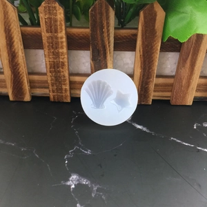 Translucent silicone mold featuring shell and starfish shapes for DIY craft making