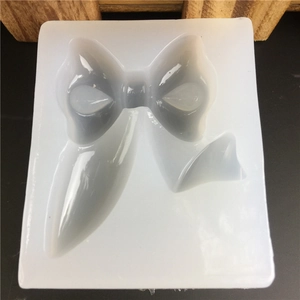 Top-down macro view of a bow-shaped silicone mold for fondant and resin crafts