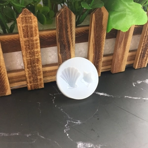 DIY silicone mold for ocean shell and starfish patterns on a dark marble surface