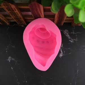 Pink 3D conch shell silicone mold for DIY fondant and chocolate baking on marble