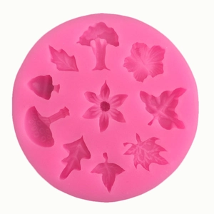 Pink silicone mold featuring various leaf, flower, tree and mushroom designs for cake decor