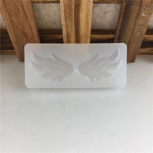 Silicone fondant mold featuring detailed symmetrical angel wings for cake decoration