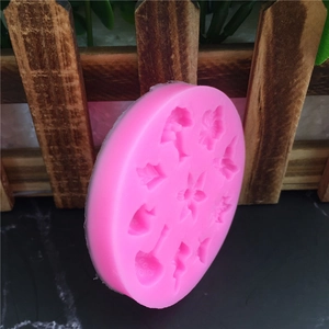 Pink silicone mold for fondant and cake decoration featuring floral and leaf patterns