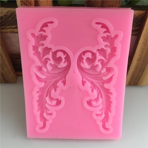 Pink silicone mold with Baroque filigree relief for fondant cake decorating and crafts
