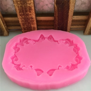 Pink oval silicone mold featuring baroque relief patterns for fondant and cake decorating