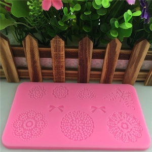 Pink silicone mold featuring floral butterfly and heart shapes for DIY cake decorating