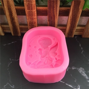 Pink silicone mold featuring an angel and stars design for fondant or handmade soap making