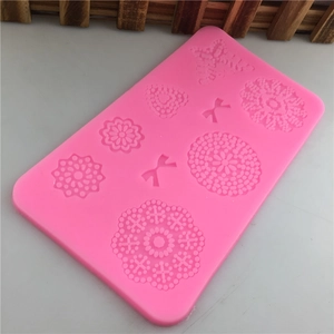 Pink silicone mold featuring floral and butterfly relief patterns for DIY fondant cake decor