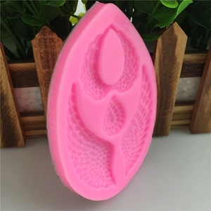 Pink silicone mold featuring angel wings and heart design for fondant cake decorating
