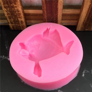 Pink circular silicone mold featuring a detailed clownfish shape for fondant and cakes
